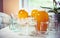 Composition of a large number of jars and three jars of honey standing on a white table against a background of light