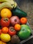 Composition of mix colored tropical and mediterranean fruits on wooden background. Concepts about decoration,