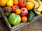 Composition of mix colored tropical and mediterranean fruits on wooden background. Concepts about decoration,