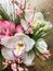 Composition of mixed colorful flowers. Composition bouquet including white orchid Cymbidium , pink genista, alstroemeria.