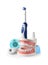 Composition with model of oral cavity and dental care items on white background.