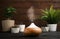 Composition with modern essential oil diffuser on black wooden table against brown background