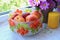 Composition with nectarines in glass bowl, candle and artificial