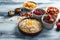 Composition with oatmeal flakes, berries and dry fruits on wooden table