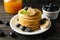 Composition with pancakes banana, blueberry and jam on wooden background