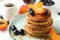 Composition pancakes and fruits on white table. Sweet breakfast