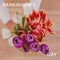 Composition of parkinson\\\'s disease day text over woman holding bunch of multi coloured tulips