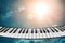 Composition of piano keyboard on sky background.