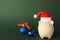 Composition with piggy bank and Christmas decor on color background.