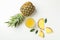 Composition with pineapple, slices and glass of juice on white background