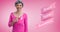 Composition of pink breast cancer text, with smiling middle age woman in pink