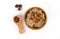 Composition Porridge , Cinnamon and Almonds and in the Spoon on top in a wooden bowl and wooden spoon, with three pine cones