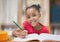 Composition of portrait of smiling african american schoolgirl in classroom