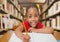 Composition of portrait of smiling african american schoolgirl in library