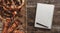 Composition of pretzels with note book, pen and sausages in dough on wooden table