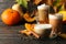 Composition pumpkin latte, cinnamon and pumpkin on wooden background