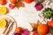 Composition with pumpkins, flowers, candles and cutlery on wooden background