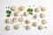 Composition with raw dumplings on white background, top view.