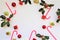 Composition with red berries, holly leafs and berries, balls, pine cones, Christmas decoration on white background
