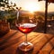 Composition of a red wine glass in a beautiful restaurant. A glass of red wine with a vineyard in the background. Sunset over a