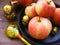 Composition of red and yellow apples on black cast iron plate with traditional russian nesting dolls matrioshka and painted spoon