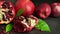 Composition ripe pomegranates, red apples, leaves on black background