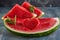 Composition with ripe watermelon, mint leaves and a heart carved in a slice of watermelon. Concept for valentines day