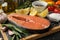 Composition salmon meat and spices on wooden background, close up