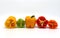 Composition of several halves of ripe sweet pepper of different colors on a light background.