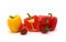 Composition of several sweet peppers and their halves of different colors on a light background.