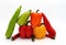 Composition of several types of sweet pepper of different shapes, colors and sizes on a light background.