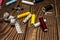 A composition of sewing items with various spools of colored thread, buttons, tape measure, scissors, a needle with threaded