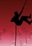 Composition of silhouette of man climbing the rope over cityscape