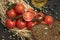 Composition of small red cherry tomatoes on an old wooden table in a rustic style, selective focus.season of vegetables.