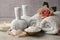 Composition with spa products, rose and candle on grey wooden table