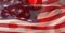 Composition of swirly red pattern with billowing american flag