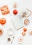 Composition with tea set, pumpkin, donuts and pastry, red apples, pomegranate and blank notebooks and albums on white background.