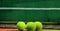 Composition of three tennis balls on tennis court with copy space