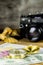 Composition of tourist compass,money,shells and fotocamera on the wooden table