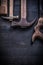 Composition of vintage rusted construction tools on wooden board