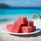 Composition of watermelon cubes close up. Beautiful fruit composition of red fruit juice. Small refreshment cut into tiny cubes