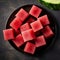 Composition of watermelon cubes close up. Beautiful fruit composition of red fruit juice. Small refreshment cut into tiny cubes