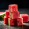 Composition of watermelon cubes close up. Beautiful fruit composition of red fruit juice. Small refreshment cut into tiny cubes