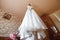 Composition - a wedding dress on a gray blue wall with decor and accessories. The concept of marriage, family relationships,