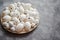 Composition of white traditional dotted Easter eggs in white ceramic plate