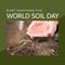 Composition of world soil day text over caucasian woman\'s hands with plant in garden