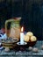 Composition of xmas symbol kutya wheat porridge with poppy and nuts , pampushki, uzvar compote of dried fruits , burning candle on
