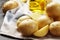 Composition of young potatoes, spices, butter on a gray background