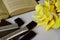 Compositionof yollow roses book and chocolate