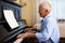 Compositor creating new music with piano at home
